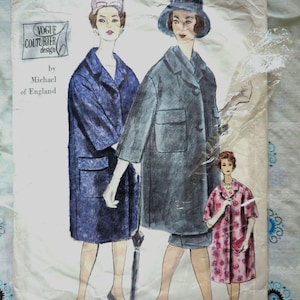 May include: Vintage Vogue Couturier design sewing pattern by Michael of England. The pattern features three women wearing coats. The woman on the left is wearing a blue coat, the woman in the center is wearing a gray coat, and the woman on the right is wearing a pink floral print coat.