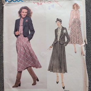 May include: A Vogue American Designer sewing pattern envelope by Don Sayres, featuring illustrations of a blazer, a blouse with a tie-neck, and a plaid skirt. The envelope includes the text Vogue American Designer, Don Sayres, and 1964 Pattern/Patron.