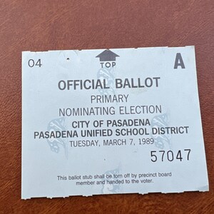 May include: A white ballot with blue text for a primary election in Pasadena, California. The ballot is for the City of Pasadena and the Pasadena Unified School District. The date of the election is Tuesday, March 7, 1989. The ballot number is 57047.