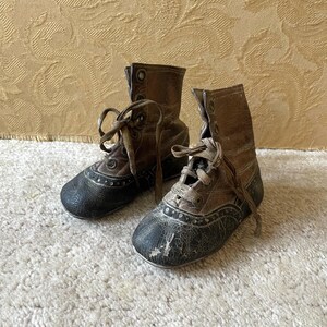 Vintage baby shoes antique toddler leather knick knack decorative collectible medieval tattered high top worn