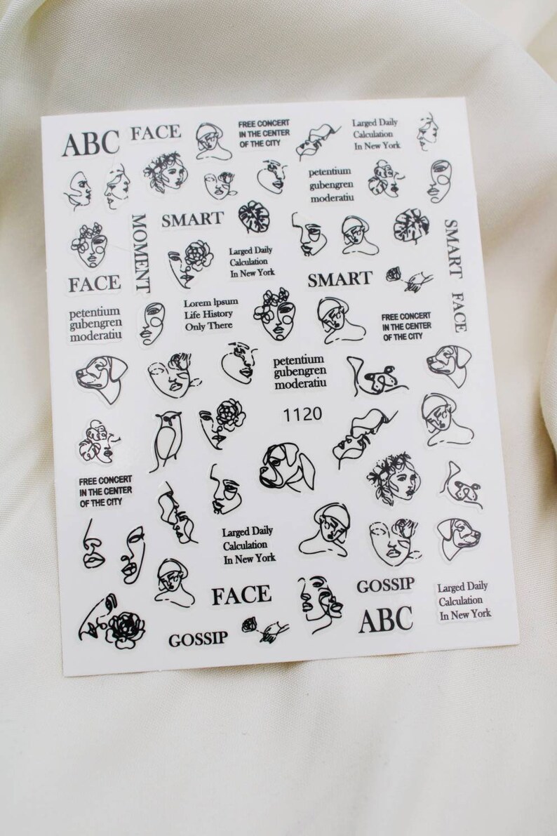 May include: A sheet of black and white nail stickers with various designs, including faces, flowers, and text. The text includes "ABC Face", "Smart", "Gossip", "Free Concert in the Center of the City", "Larged Daily Calculation in New York", "Petentium Gubengren Moderatiu", "Lorem Ipsum Life History Only There", and "1120".
