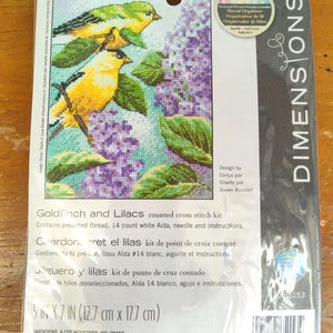 Può includere: Un kit di punto croce contato con un cardellino e fiori di lillà. Il kit include filo pre-ordinato, tessuto Aida bianco a 14 punti, un ago e istruzioni. Il kit misura 5 pollici per 7 pollici o 12,7 cm per 17,7 cm.