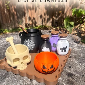 May include: A digital download set featuring a black cauldron with a white spiderweb, a beige skull mortar and pestle, an orange pumpkin bowl, and three small potion bottles in black, purple, and white with ghost, witch, and cat graphics.