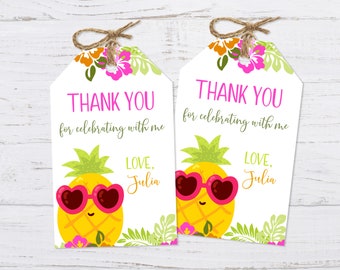 May include: Two white thank you tags with a pineapple wearing pink heart-shaped sunglasses and green leaves. The text on the tags reads "Thank you for celebrating with me" and "Love, Julia".