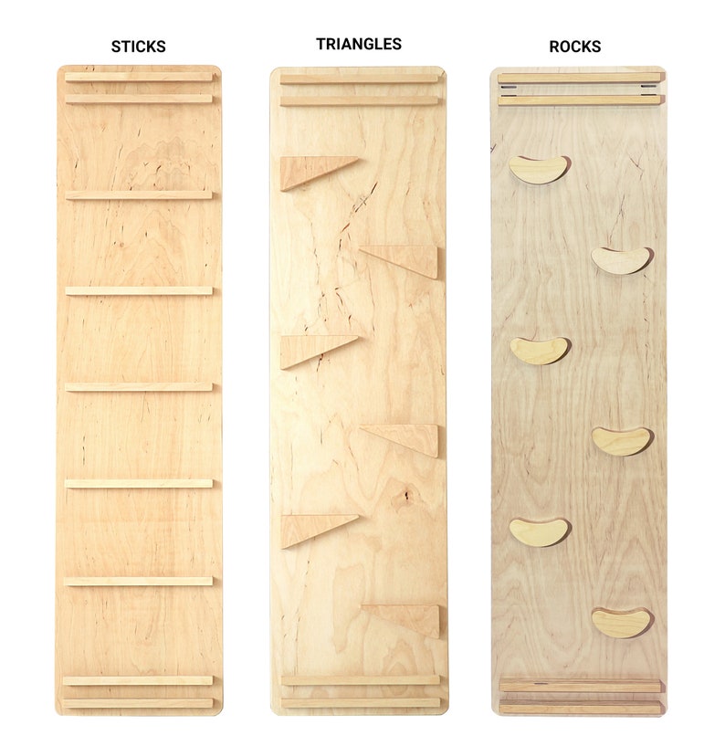 May include: Three wooden climbing wall panels with different shapes. The first panel is labeled "STICKS" and has five horizontal wooden sticks. The second panel is labeled "TRIANGLES" and has four wooden triangles. The third panel is labeled "ROCKS" and has five wooden rock shapes.
