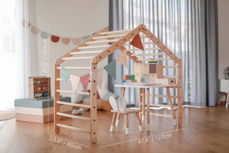 May include: A wooden playhouse with a climbing ladder, a small table and chair, and a decorative bunting. The playhouse is 41 inches tall, 23.6 inches wide, and 47.4 inches long.
