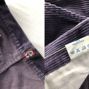 May include: A pair of purple corduroy pants with a white label that says "100% Polyester" and a blue label that says "Goon" with a circle and a red stripe. The pants are made in Belgium and are size 40.