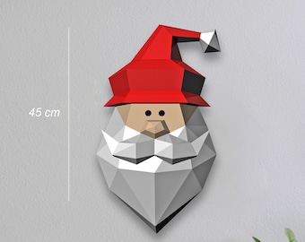 Puede incluir: Una cabeza de Papá Noel de papelcraft blanca y gris con un gorro rojo. La cabeza de Papá Noel mide 45 cm de alto y 25 cm de ancho.