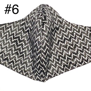 Peut inclure: Masque facial &agrave; motif noir et blanc avec des boucles d'oreille r&eacute;glables. IS #6.