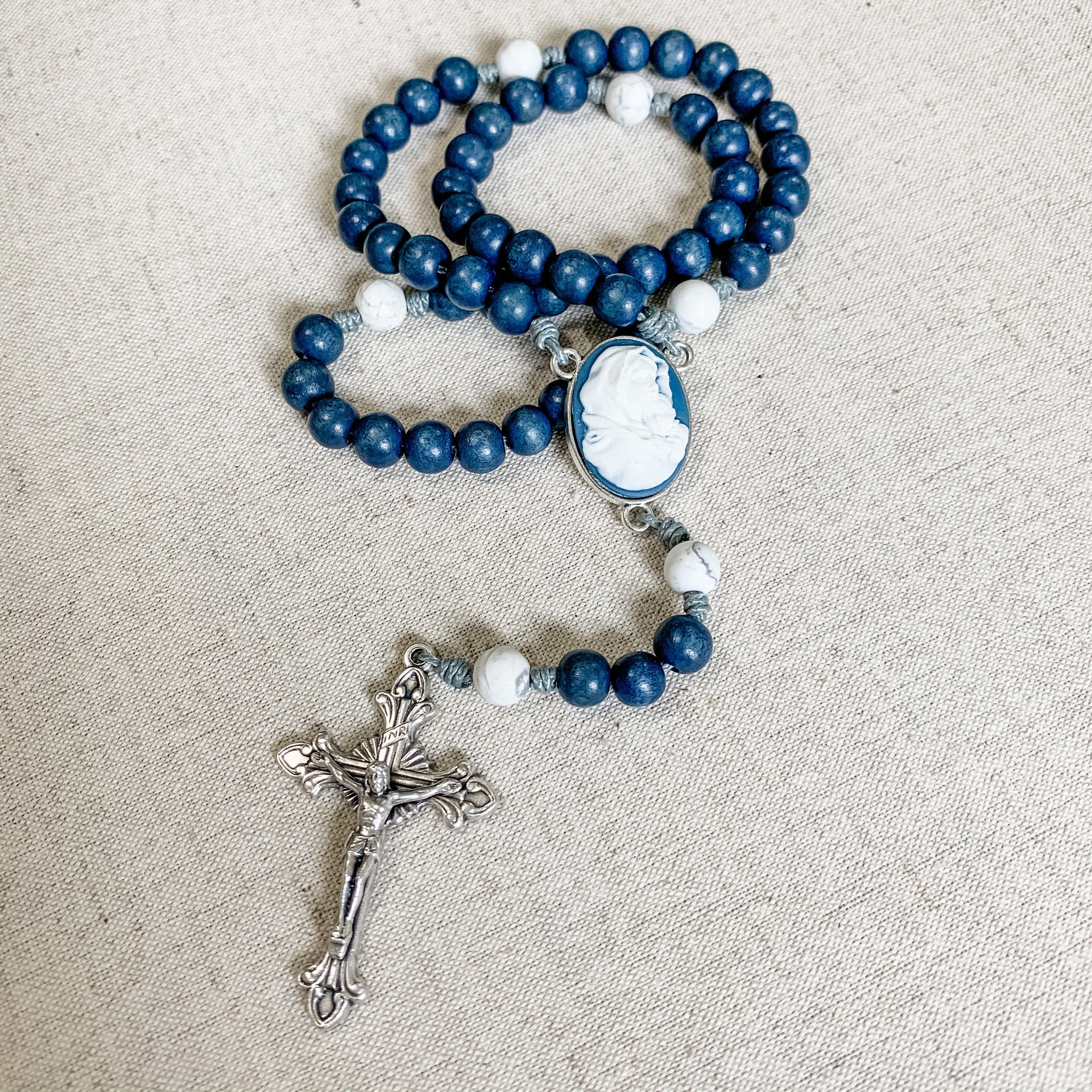 Catholic rosary with dark blue Madonna of the Streets cameo centerpiece, dark blue wood beads and howlite gemstone beads and micro cord