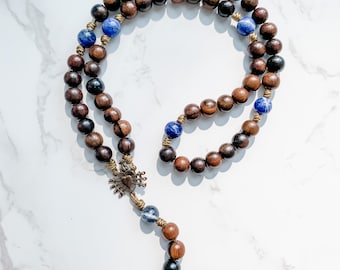 Seven Sorrows Rosary with bronze parts, ebony beads, sodalite beads, and micro cord