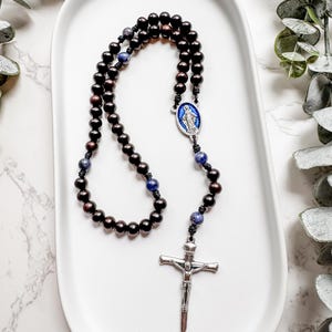 Catholic rosary by Refuge Rosaries with ebony wood and blue sodalite gemstone beads and a Miraculous Medal centerpiece | Micro Cord Rosary