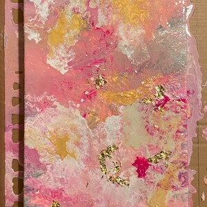 May include: Abstract painting on canvas with pink, white, gold, and silver paint. The painting has a swirling, marbled effect with gold leaf accents.