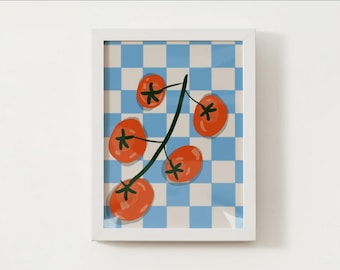 May include: A framed art print showing a tomato vine with six orange tomatoes. The background is a blue and white chequered pattern. The tomatoes have green stems and are set against a white frame.