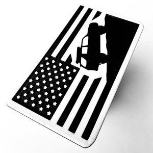 May include: A black and white American flag with a silhouette of a jeep driving over a hill. The flag is on a white background.