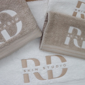 Custom embroidered towels with business logos. Multiple sizes: face cloth, hand towel, bath towel, bath sheet. Multiple colours. UK-made.