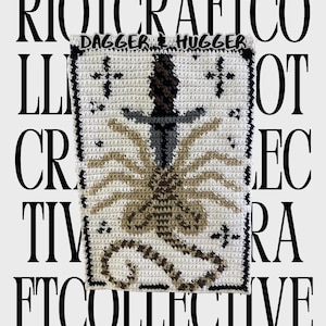 May include: A cream-colored, crocheted decorative piece with a central dagger design and a stylized insect-like figure. The piece is bordered in black and features the text "DAGGER HUGGER" at the top. The background includes the text "RIOT CRAFT CO COLLECTIVE".