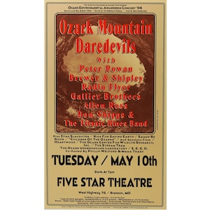 May include: A vintage concert poster advertising the "Ozark Mountain Daredevils" with Peter Rowan, Brewer & Shipley, Radio Flyer, Gallier Brothers, Allen Ross, Don Shipps & The Titanic Blues Band. The concert is scheduled for Tuesday, May 10th at the Five Star Theatre in Branson, Missouri.