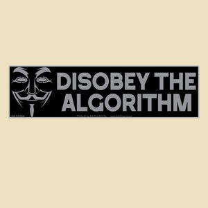 May include: A black bumper sticker with the text "DISOBEY THE ALGORITHM" in grey letters. The sticker features the stylized mask of Guy Fawkes on the left side. The background is a light beige colour.