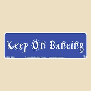May include: Blue rectangular sticker with white text that reads "Keep On Dancing". The sticker has a white border and a copyright symbol with the year 2020 and the text "JB300".