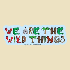 May include: A blue sticker with the text "WE ARE THE WILD THINGS" in white letters. Each letter is formed by a different animal or plant, such as a crab, alligator, monkey, and palm tree.