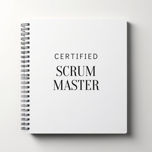 May include: A white spiral-bound notebook with the words "CERTIFIED SCRUM MASTER" printed in black. The notebook is open, and the spiral binding is visible on the left side.
