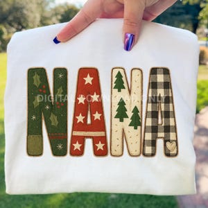 May include: White sweatshirt with the word "NANA" in festive, appliqued letters. The letters feature holiday-themed designs: holly, stars, Christmas trees, and a buffalo check pattern. The word "DIGITAL OWNED ONLY" is printed on the sweatshirt.