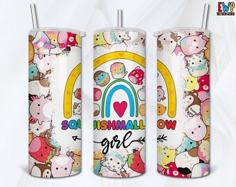 May include: A cylindrical tumbler with a metal straw featuring a colorful pattern of various plush toy characters, a central rainbow graphic with a pink heart, and the text "SQUISHMALLOW girl" in a mix of bold block letters and black script font.