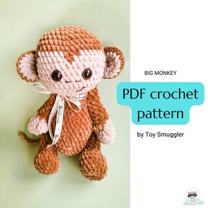 May include: A brown and beige crocheted monkey toy with a white ribbon around its neck. The toy is sitting on a green surface. The text "BIG MONKEY PDF crochet pattern by Toy Smuggler" is in the background.