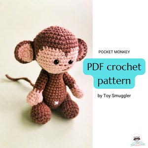May include: A brown crocheted monkey sitting on a light green background. The monkey has a pink face and ears. The text "Pocket Monkey PDF crochet pattern by Toy Smuggler" is in the upper right corner of the image.