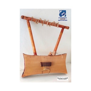 May include: A wooden lyre with strings and a wooden soundboard. The lyre is a musical instrument used in ancient times.