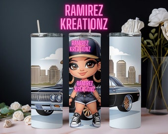 May include: A white tumbler with a cartoon illustration of a girl wearing a black and white baseball cap and a blue jean skirt. The girl is standing in front of a black car with a city skyline in the background. The tumbler has the text "RAMIREZ KREATIONZ" on it.