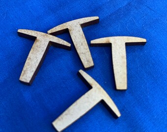 May include: Four unfinished wooden T-shaped pieces on a blue fabric background.