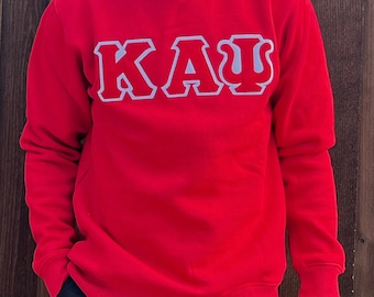 Pode incluir: Camisola de cor vermelha com letras brancas que dizem "ΚΑΨ".