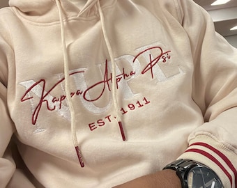 Kappa Alpha Psi sudadera con capucha color crema con bordado