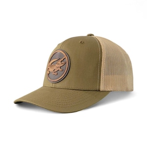 May include: Olive green baseball cap with a brown leather patch featuring an alligator design. The cap has a mesh back and a curved brim. A stylish accessory for outdoor activities.