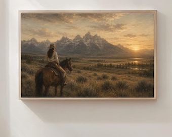 May include: A rectangular framed wall art print depicting a landscape scene with a person on horseback facing snow-capped mountains at sunset. The warm golden light illuminates the grassy plains and the distant peaks under a cloudy sky.