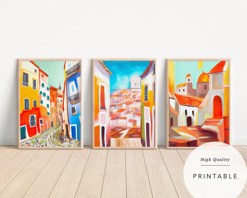 May include: Three colourful paintings depicting a street scene in a European city. The paintings feature bright colours, including yellow, orange, red, blue, and green. The buildings are painted in a stylised manner, with rounded corners and whimsical details. The paintings are framed in wood and are ready to hang.