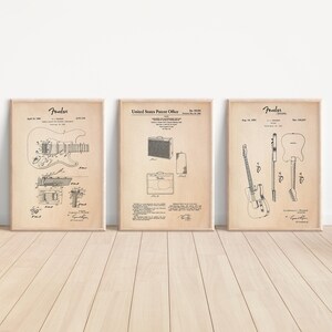 May include: Three vintage patent prints for Fender guitars and amplifiers. The prints are in black and white and feature line drawings of the instruments. The prints are on a beige background.