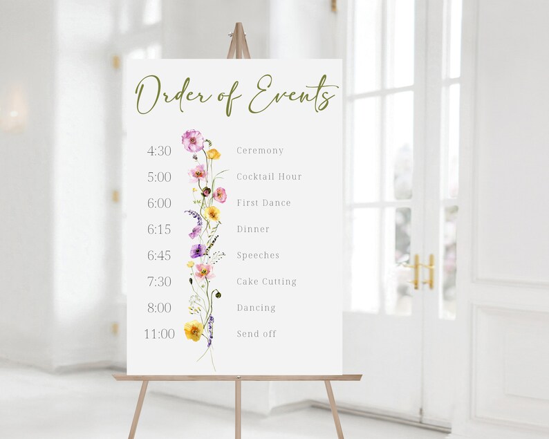 May include: A white sign with a floral design and the text "Order of Events" with a list of events and times for a wedding reception.
