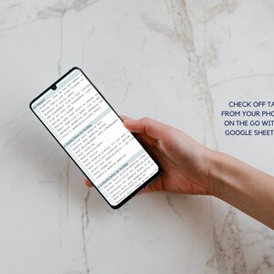 May include: A smartphone displaying a checklist for wedding planning. The checklist includes tasks such as notifying family and close friends, finding a venue, setting a budget, and booking a photographer. The text "CHECK OFF TASKS FROM YOUR PHONE OR ON THE GO WITH THE GOOGLE SHEETS APP" is displayed at the top of the image.