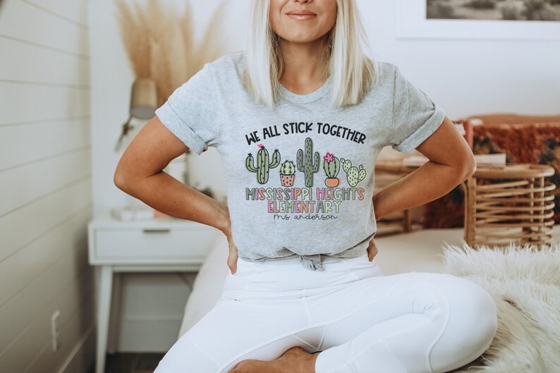 May include: A grey t-shirt with a cactus graphic and the text "We all stick together Mississippi Heights Elementary Mrs. Anderson".