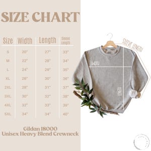 May include: Size chart for a Gildan 18000 Unisex Heavy Blend Crewneck sweatshirt. The chart shows measurements in inches for width, length, and sleeve length for sizes S through 5XL.