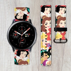 May include: A black smartwatch with a white watch band featuring a colorful pattern of Disney princesses. The watch face displays the date, time, and temperature. The text on the watch face reads "AUG 05 23° London".