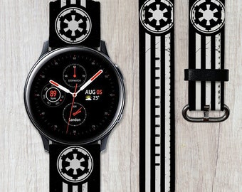 May include: A black and white watch band with a Star Wars Imperial logo and stripes. The watch face shows the time, date, and weather. The band is compatible with Samsung Galaxy Watch 46mm.