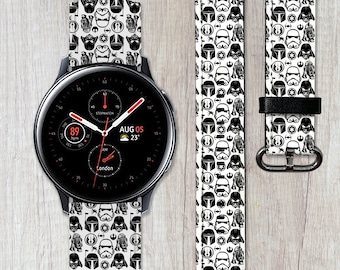 May include: Black and white watch band with a Star Wars pattern. The band features images of Darth Vader, Stormtroopers, and other characters from the Star Wars universe. The watch face displays the time, date, and temperature.