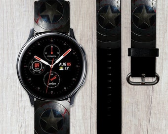 May include: A black smartwatch with a round face and a black band. The watch face displays the time, date, and other information. The band has a design of a red, white, and blue star on a black background. The watch is on a wooden surface.