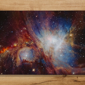 May include: A vibrant nebula with swirling clouds of red, orange, blue, and white against a dark starry background.