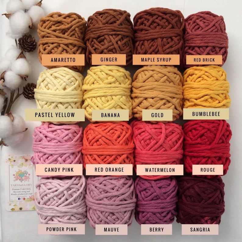 May include: A collection of 16 cotton rope yarn skeins in various shades of brown, yellow, orange, pink, and red. The skeins are arranged in four rows of four, with each skein labeled with a color name.