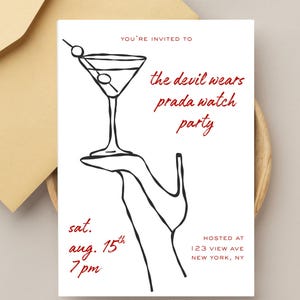 May include: White invitation card with a black and red design. The card features a martini glass illustration and text that reads "the devil wears prada watch party". Additional text includes the date, time, and location.
